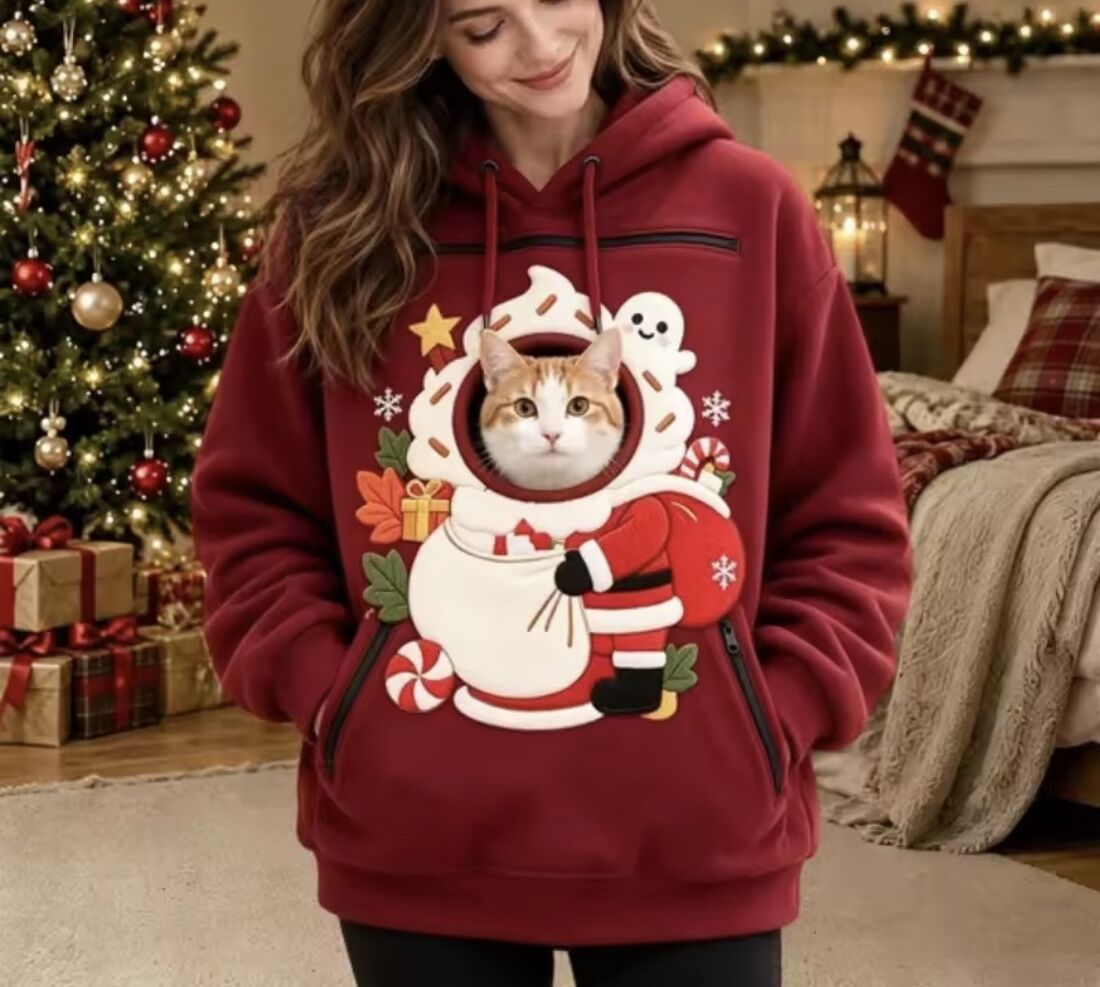 Christmas Pouch Hoodie in Santa Red, worn with a cat peeking out of the pouch